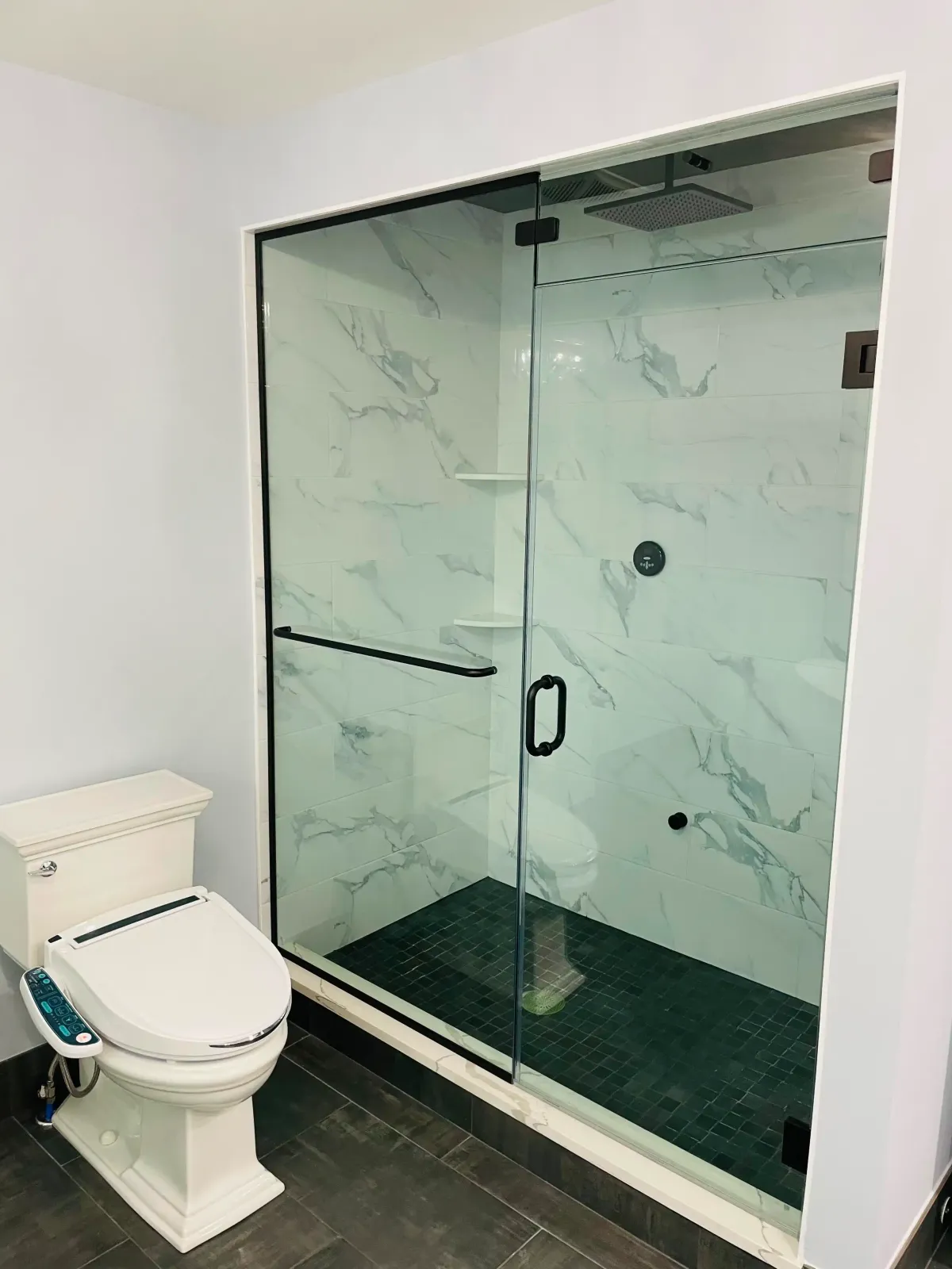 Frameless glass corner shower enclosure installed in a modern bathroom