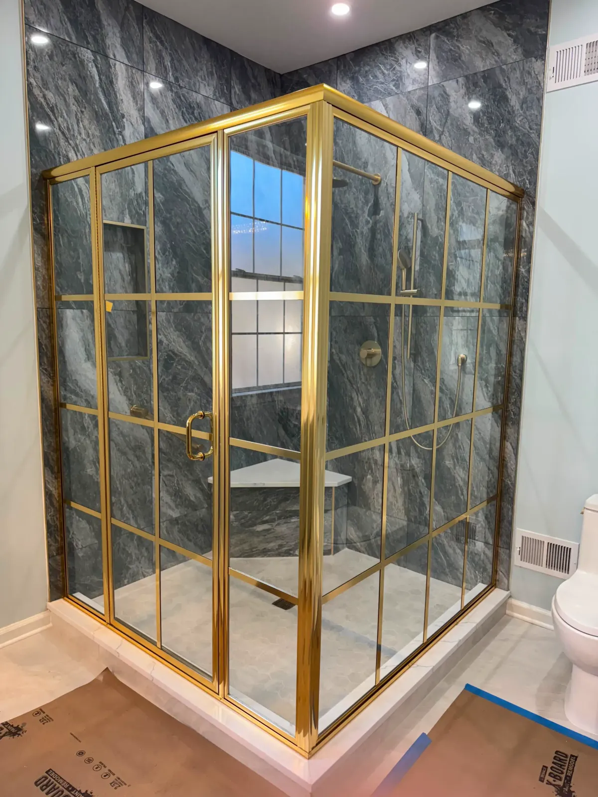 Barn-style sliding glass shower door on a tiled enclosure