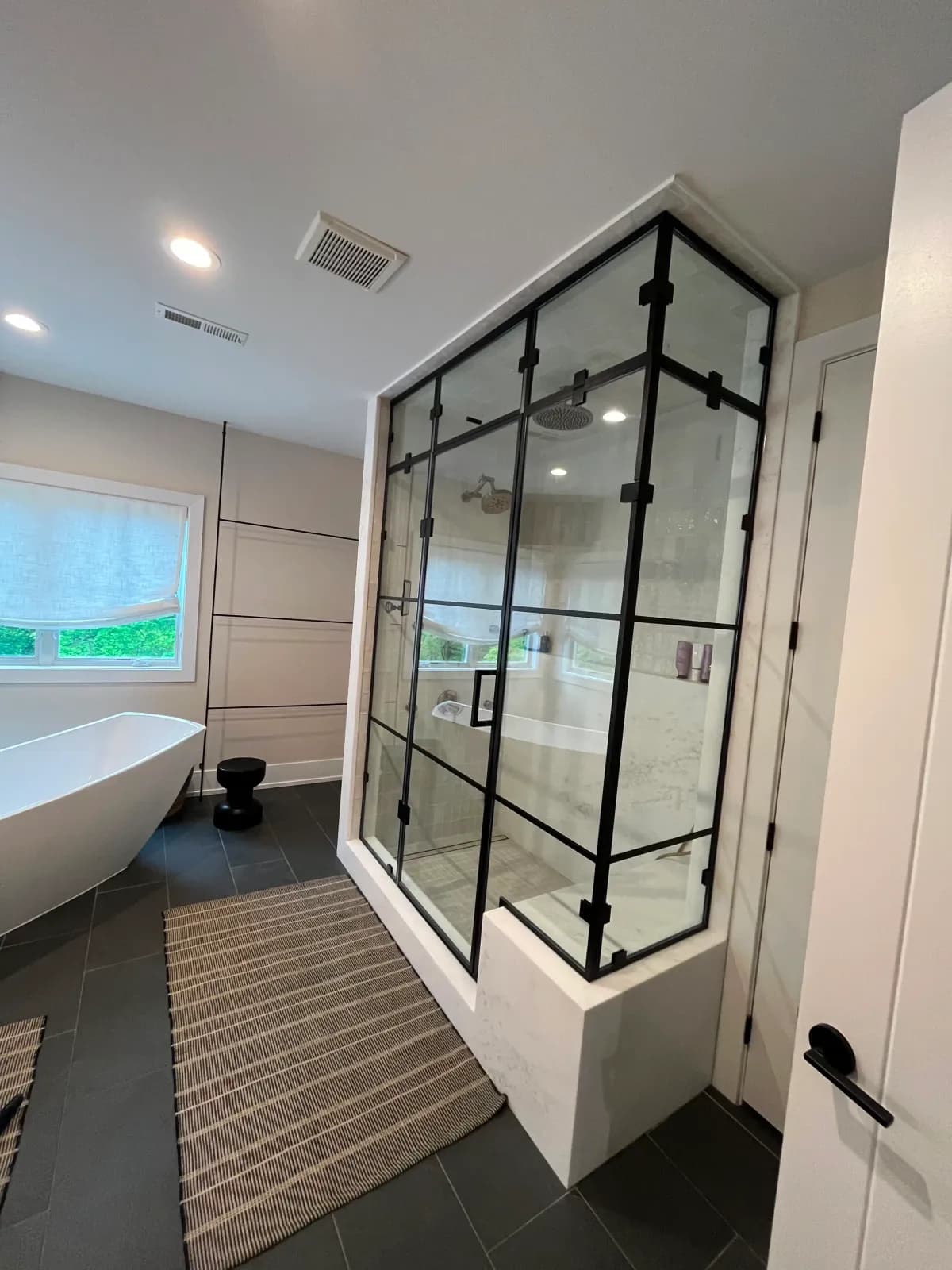 Custom barn-style sliding glass shower door installed by RB Glass